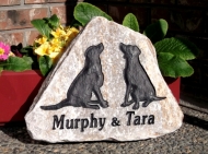 2 dogs remembered on a garden stone