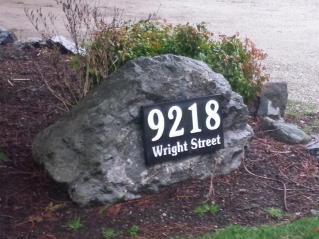 address plaque on rock