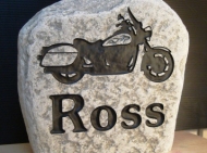 Engraved family name stone with a motorcycle